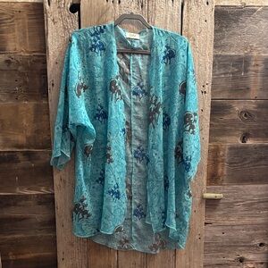 Western kimono with a leather tooled look and bronc riders